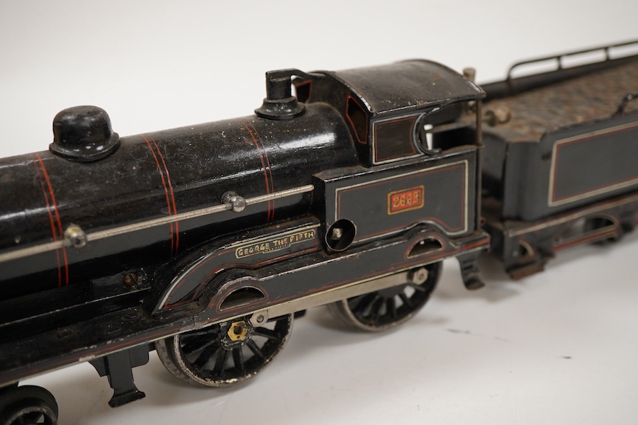An 0 gauge Bing for Bassett-Lowke tinplate clockwork LNWR 4-4-0 tender locomotive, George the Fifth 2663, in red lined black livery with original clockwork mechanism